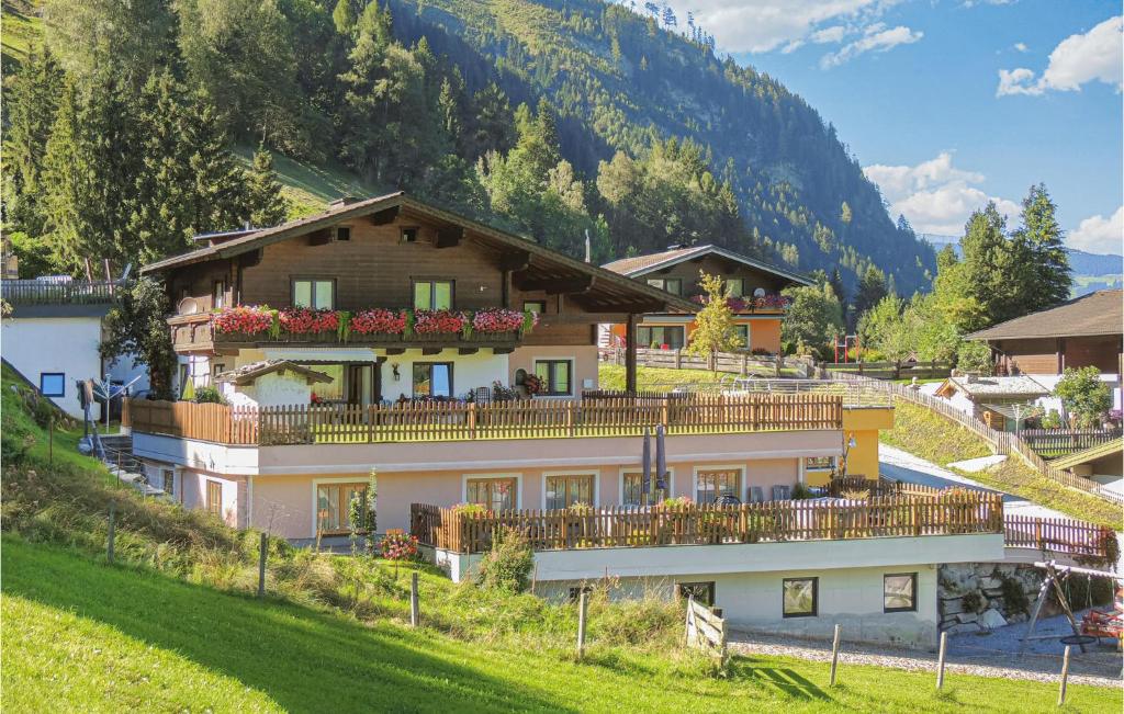 a large house with a balcony on a hill at Amazing Apartment In Rauris With 1 Bedrooms in Rauris