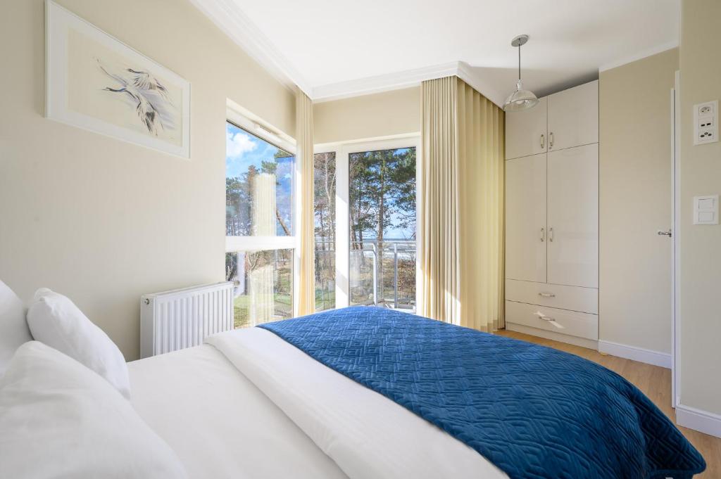 Posteľ alebo postele v izbe v ubytovaní Navango Apartament z widokiem na morze