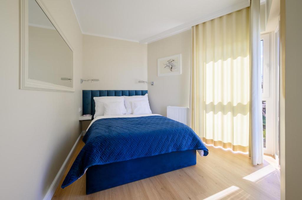 Posteľ alebo postele v izbe v ubytovaní Navango Apartament z widokiem na morze