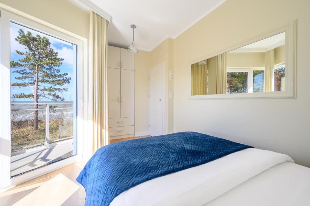 Posteľ alebo postele v izbe v ubytovaní Navango Apartament z widokiem na morze