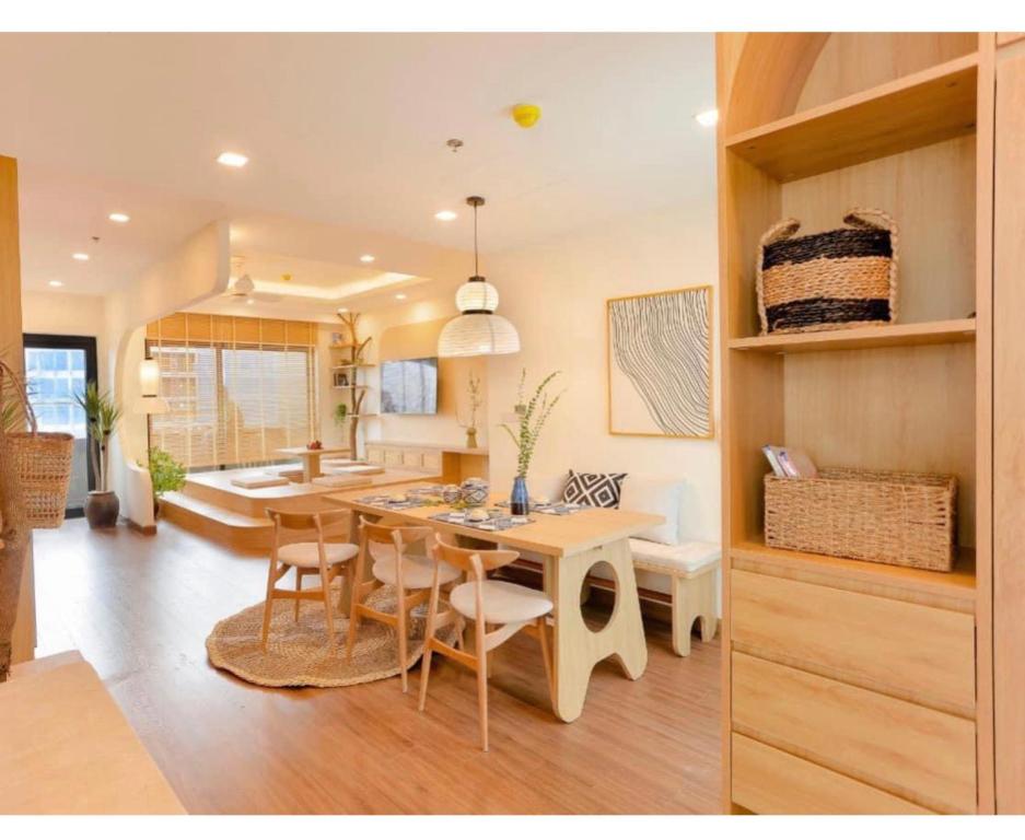 a kitchen and dining room with a table and chairs at FLC Luxury Apartment Quy Nhon in Quy Nhon