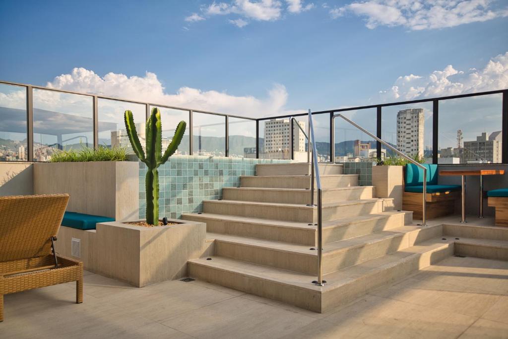 a staircase on the roof of a building with a cactus at Life Residence in Belo Horizonte