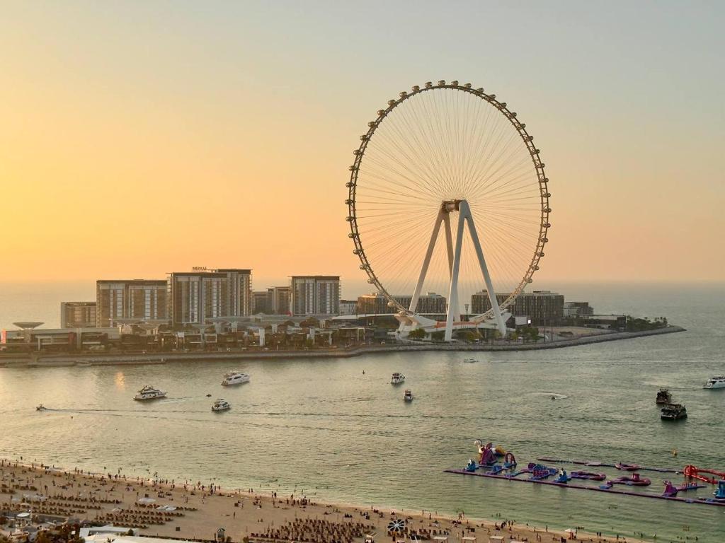 a ferris wheel in the water next to a beach at AR Holiday Home JBR 2 in Dubai