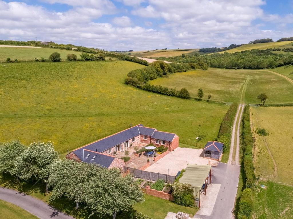 an aerial view of a house in a field at 4 Bed in Dorchester 42204 in Frampton