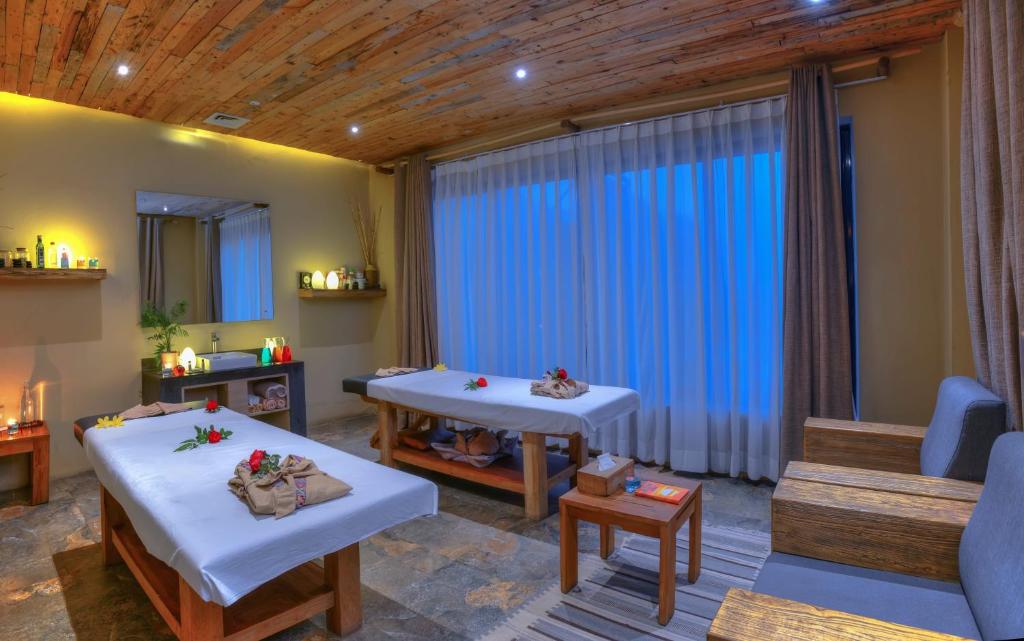 a living room with two beds and a couch at Sarangkot Mountain Lodge in Pokhara