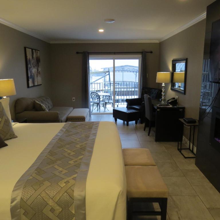 a hotel room with a bed and a living room at Dockside Suites in Digby