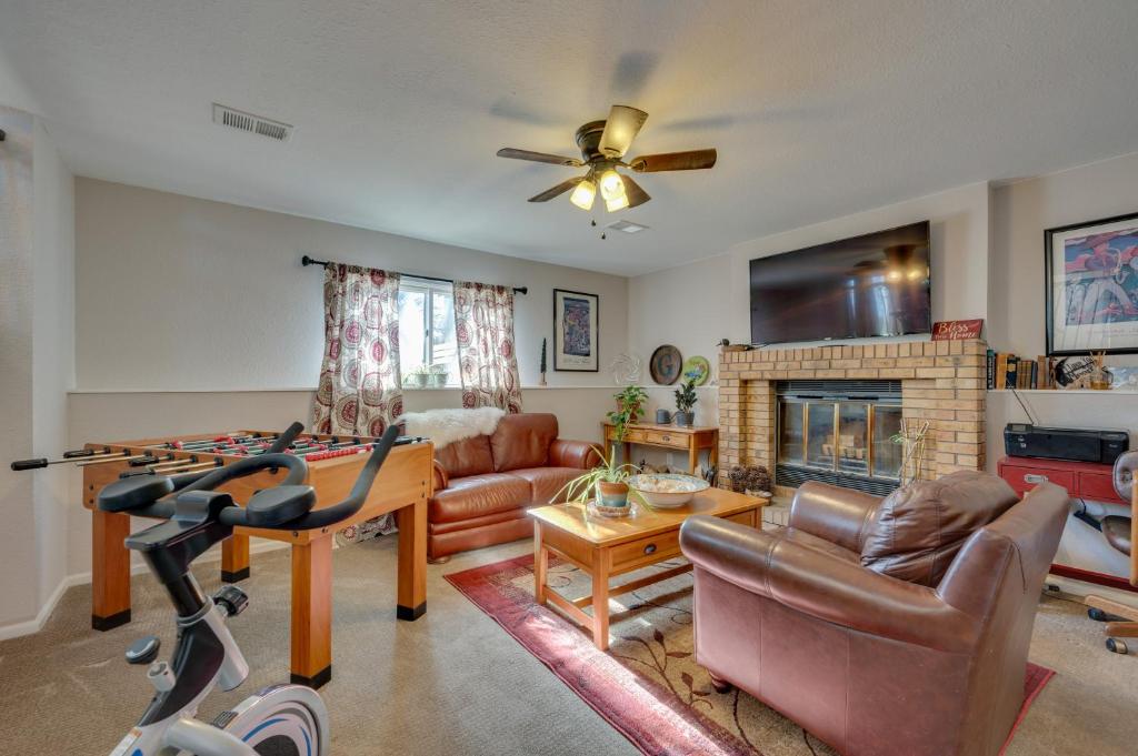 a living room with a couch and a fireplace at Loveland Home with Private Hot Tub and Wood Fireplace! in Loveland