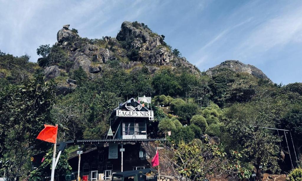 a building on a hill with a mountain at Eagles nest in Wayanad