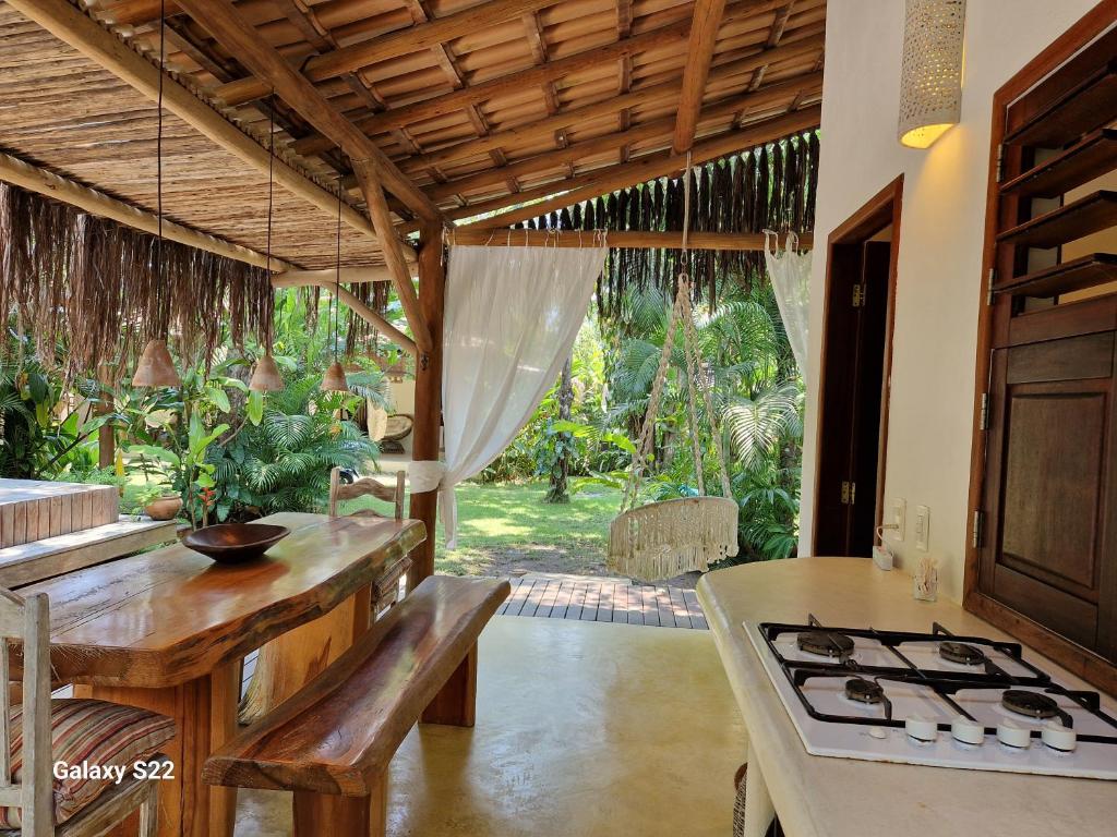 a kitchen with a counter and a stove top oven at Mini Casa com Jacuzzi e Piscina in Trancoso