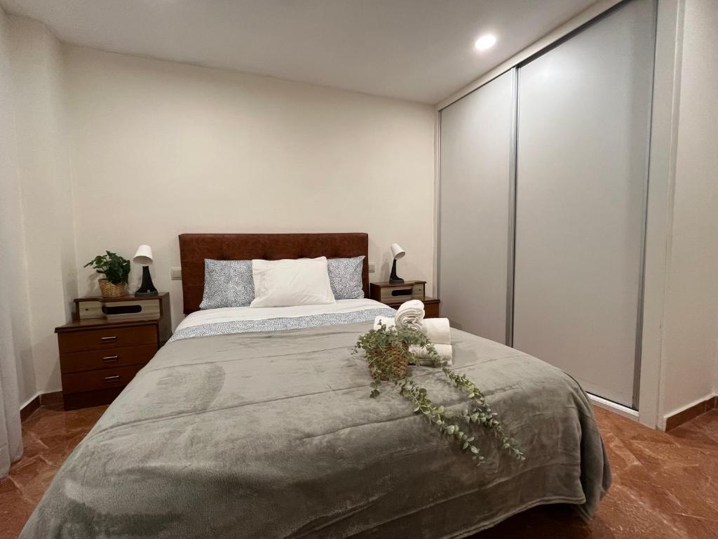 a bedroom with a large bed with white walls at Apartamento Alcalá in Madrid