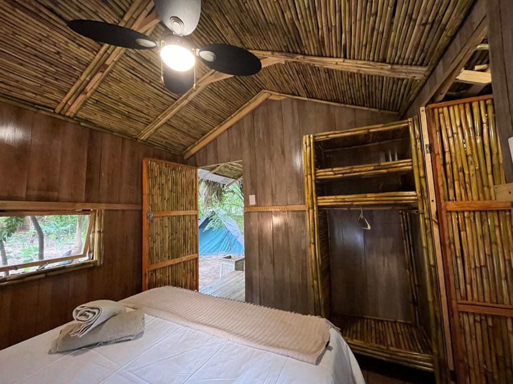a bedroom with a bed and a ceiling fan at Sandton Safari Camp in Johannesburg