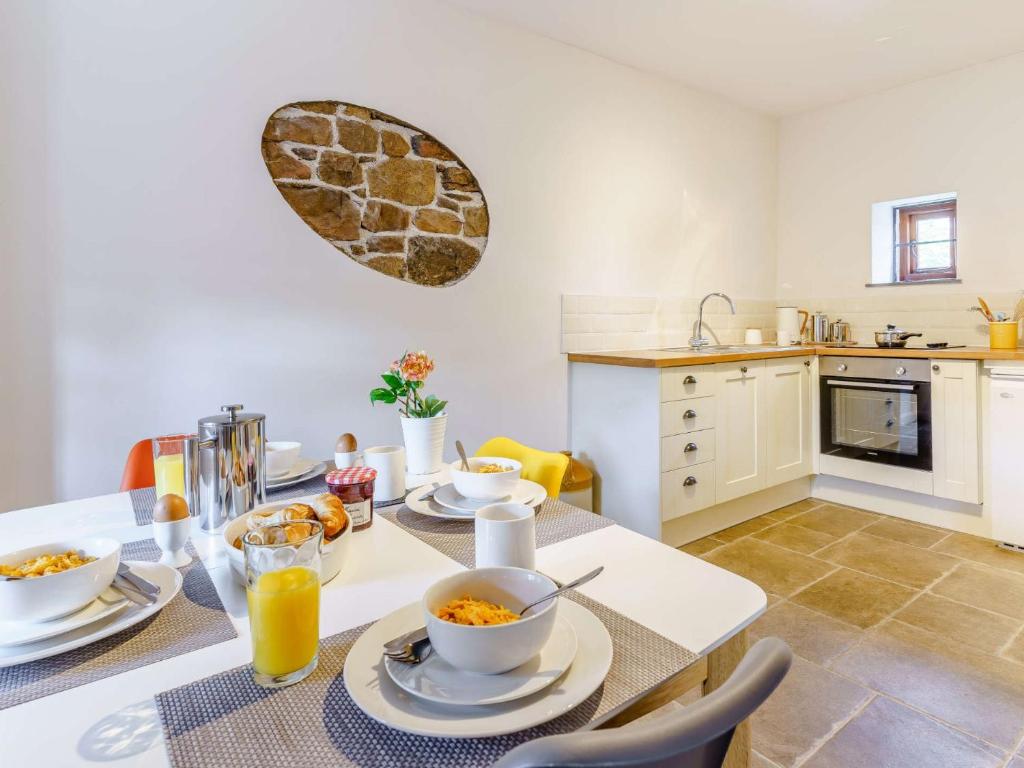 a kitchen with a table with bowls of food on it at 2 bed property in Nantyglo 82707 in Nantyglo