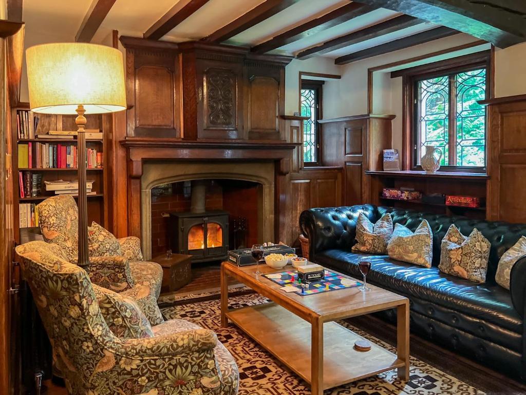 a living room with a couch and a fireplace at Daweswood, Patterdale in Patterdale