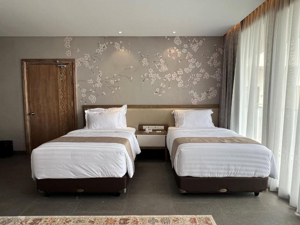 Postel nebo postele na pokoji v ubytování Tabebuya Resto & Resort