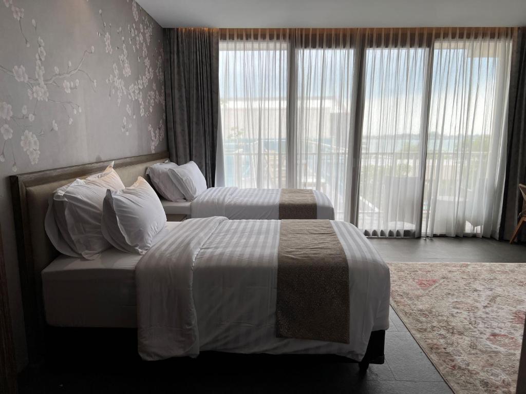 Postel nebo postele na pokoji v ubytování Tabebuya Resto & Resort