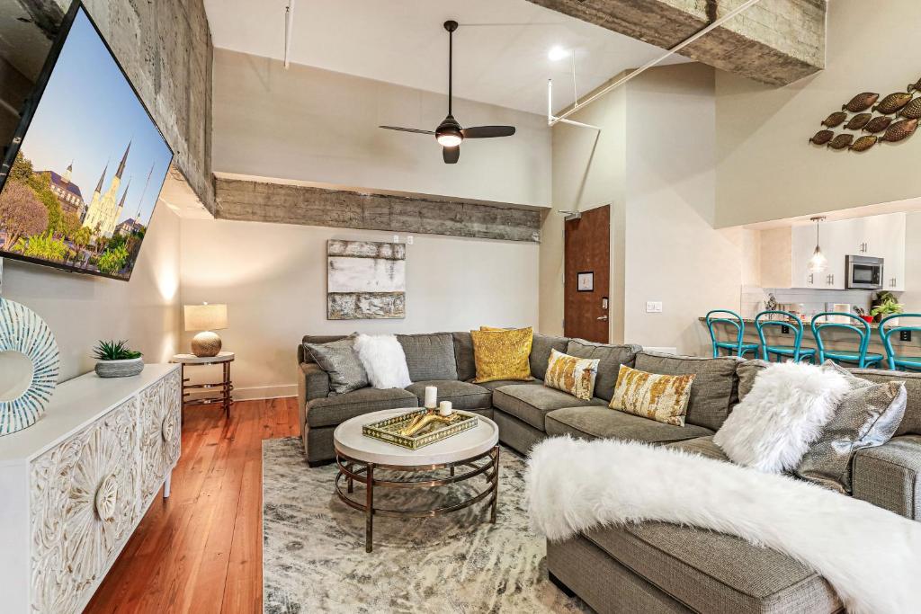 a living room with a couch and a table at Upscale Condos and Penthouses Close to Canal and Bourbon St in New Orleans
