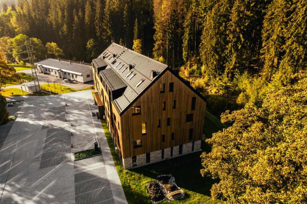 an overhead view of a large building with trees at Apartmány Mlýn Herlíkovice in Hořejší Vrchlabí