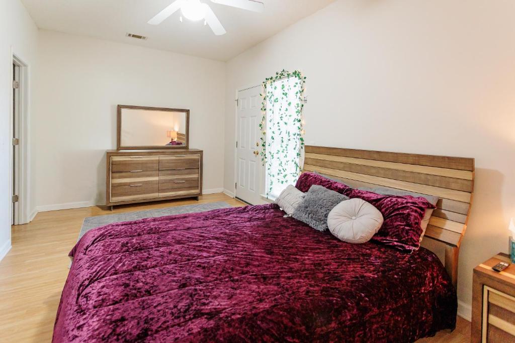 a bedroom with a large bed and a mirror at Private 2 bedroom and 2 bathroom in Savannah in Savannah