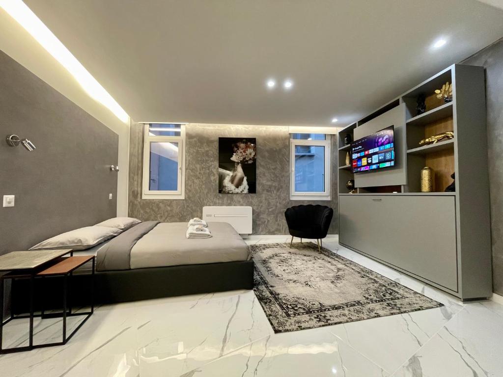 a bedroom with a bed and a television in it at TALEDA Apartments - Modern Apartments & Self Checkin in the Old Town in Lugano