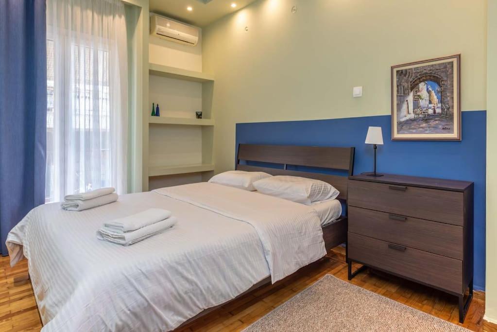 a bedroom with a bed with two towels on it at City Haven: 1-BR, Central Athens in Athens