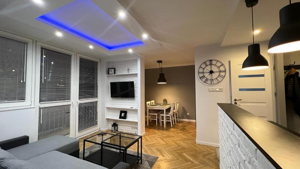 a living room with a blue light on the ceiling at Project Comfort Apartament Grzybowska 30/1211 in Warsaw