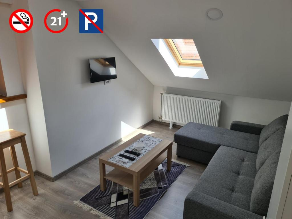 a living room with a couch and a table at Old Town apartments in Novi Sad
