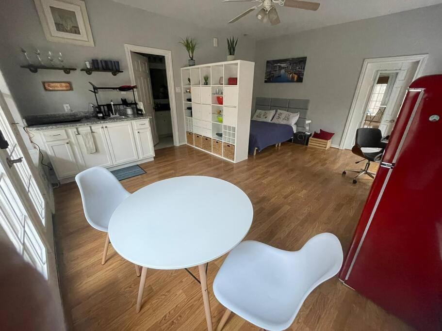 a living room with a white table and white chairs at Stylish Studio in Montrose - The Italian Plaza in Houston
