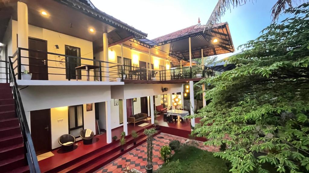 an exterior view of a house with a courtyard at Marari Charlys Homestay in Mararikulam
