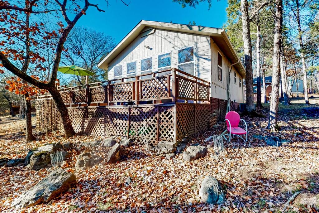 a house with a pink chair in the yard at The Cove - Main House in Golden