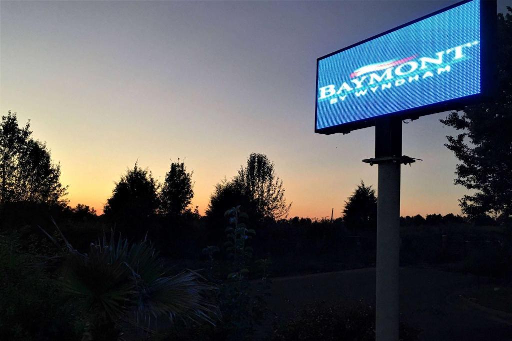 a sign for a bank with the sunset in the background at Baymont by Wyndham Adairsville in Adairsville