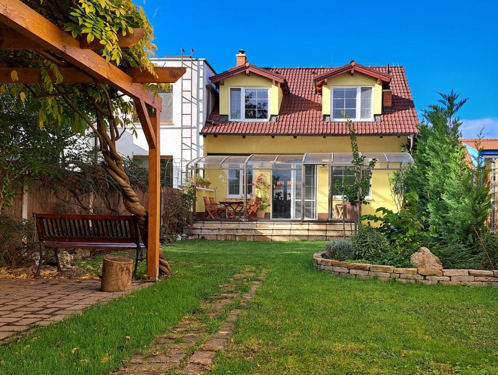 a house with a bench in the yard at Family house with garden and sauna in Trnávka