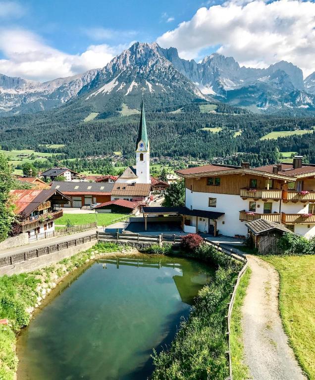 a small town with a church and a mountain at Kaiserapart Steinadler - ELLMAU Zentrum in Ellmau