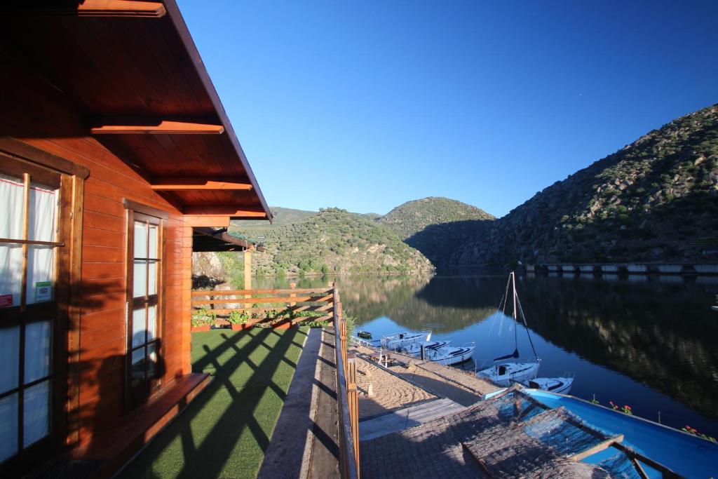 a cabin with a view of a lake and mountains at Douro Yacht Charter & Bungalows in São João da Pesqueira