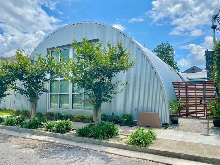 a large white building with trees in front of it at Moon 101 - Full Moon Suite - 2BR 2 5 Bath + Living in New Orleans