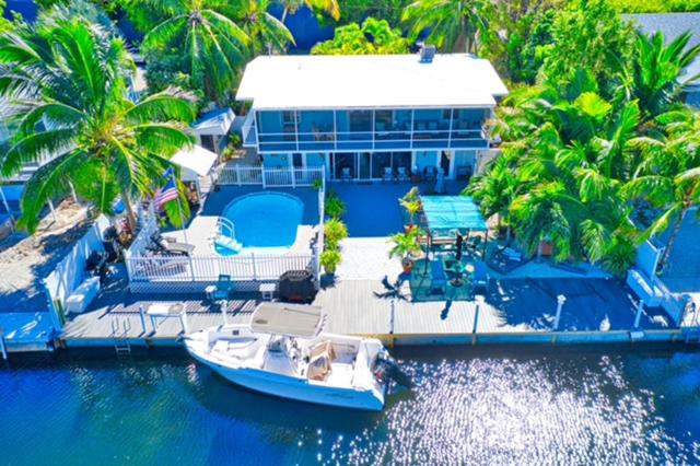 a boat is docked at a house on the water at Parrot Eyes in Tavernier