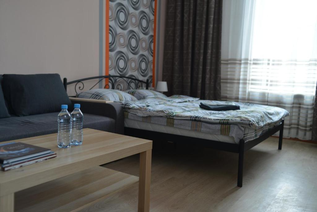 a living room with a couch and a coffee table at Uneed Rooms - Cloud 9 in Kyiv