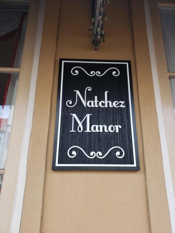 a sign on the side of a building at Natchez Manor Bed & Breakfast in Natchez