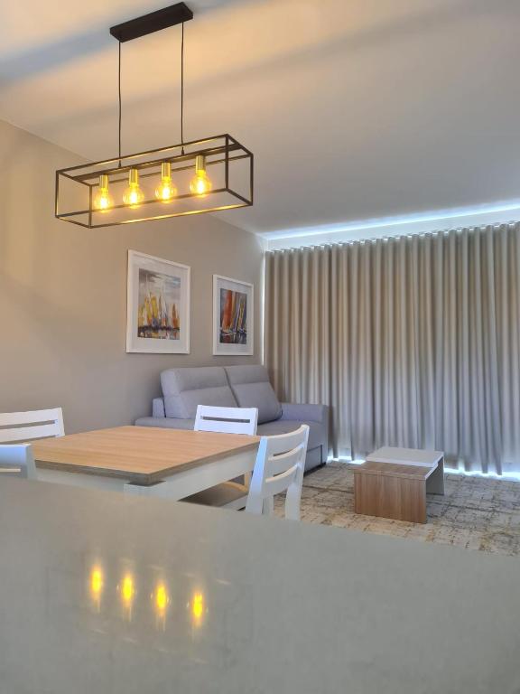 a living room with a table and a couch at Lightoasis Oasis Mar 3 in Portimão