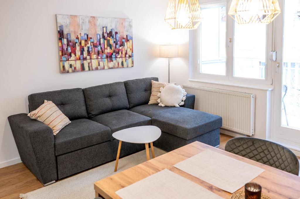 a living room with a couch and a table at Poppy Elegance City Center & Free parking in Sarajevo