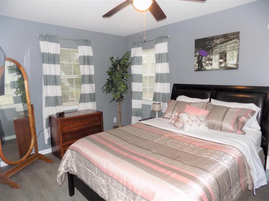 a bedroom with a bed and a dresser and a mirror at Fishing Retreat in Pensacola