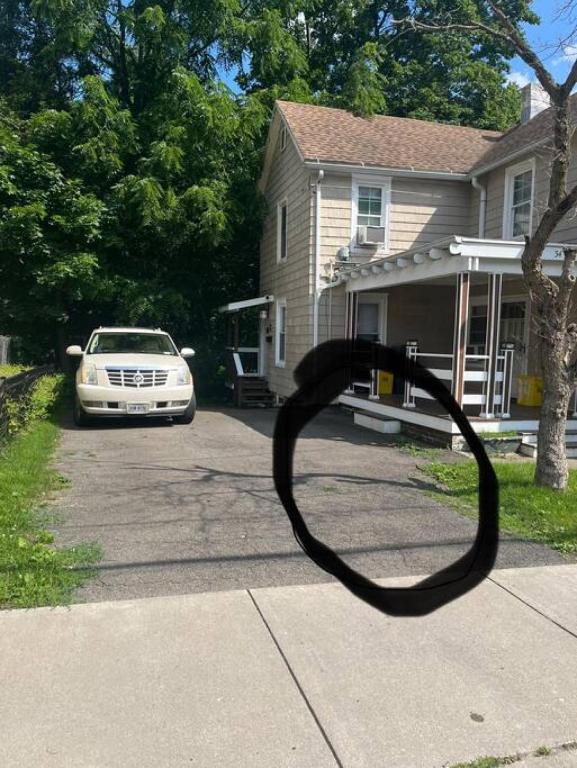 a car parked in the driveway of a house at Intimate 1 Bedroom Apt by UHS in Binghamton