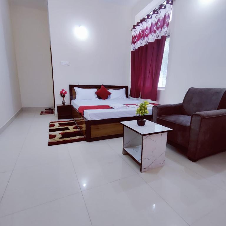 a living room with a bed and a couch at A K CONTINENTAL in Rānchī