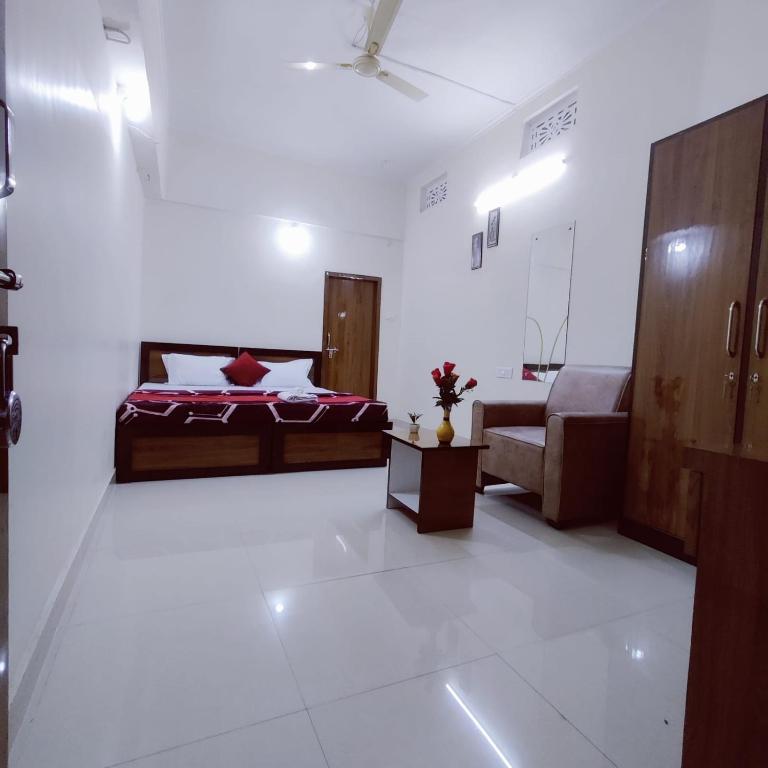 a bedroom with a bed and a living room at A K CONTINENTAL in Rānchī