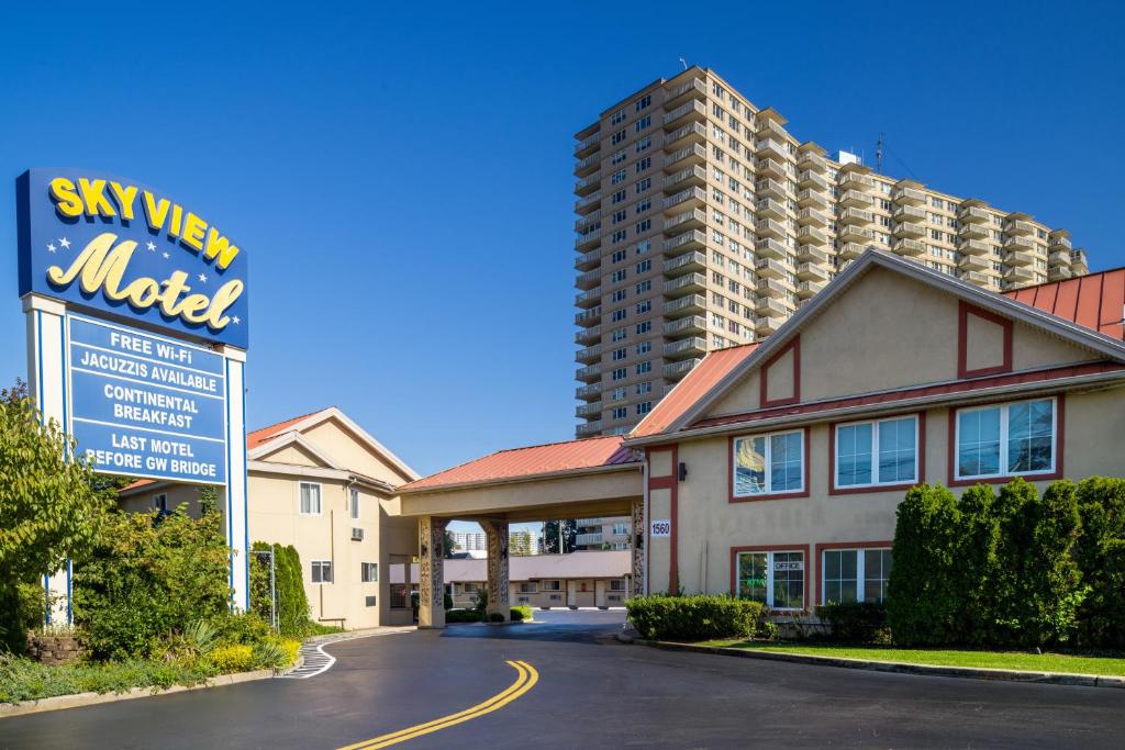 a hotel with a sign in front of a building at Skyview Motel in Fort Lee