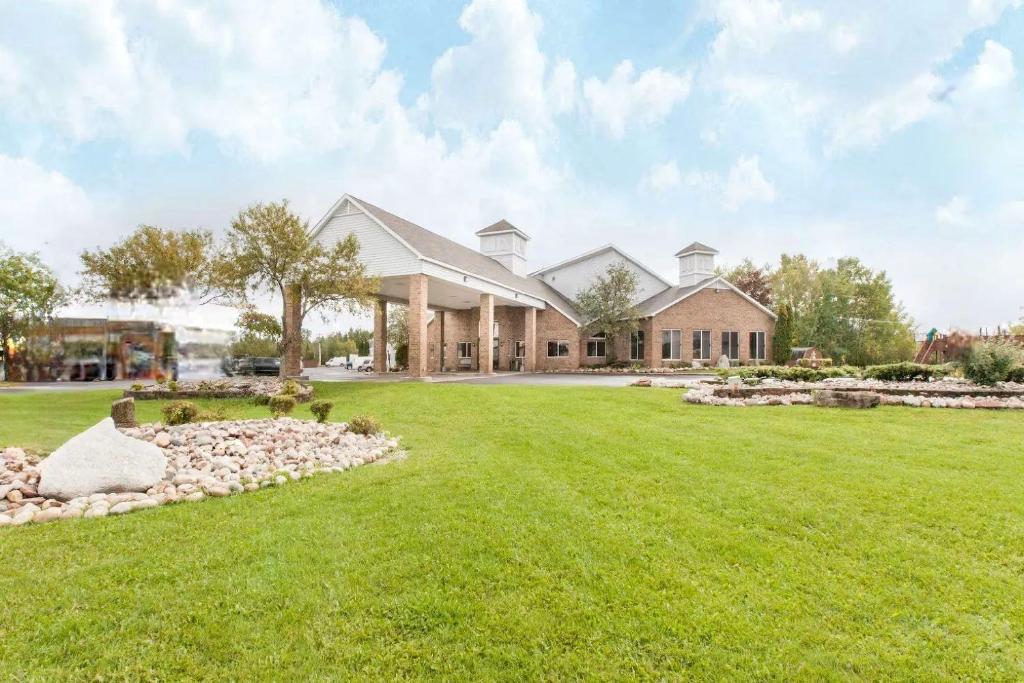 a large house with a large lawn in front of it at The Inn in Sault Ste. Marie