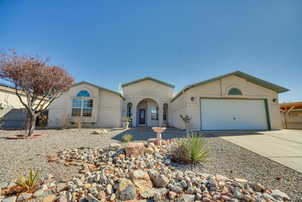 a house with a garage and a driveway at Enchanted Hills Home with Sandia Mountain Views! in Rio Rancho