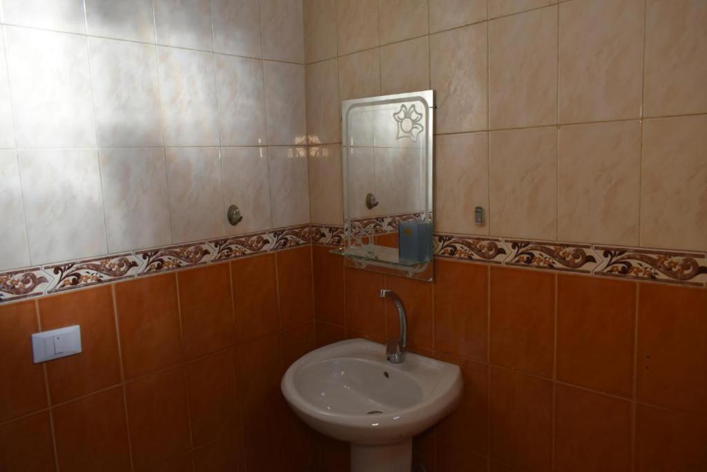 a bathroom with a sink and a mirror at safari desert in Bawiti