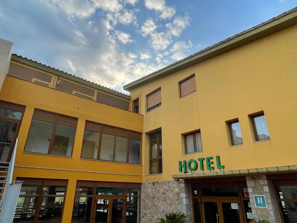 a building with a hotel sign on the side of it at Hotel Font del Pla in La Jonquera