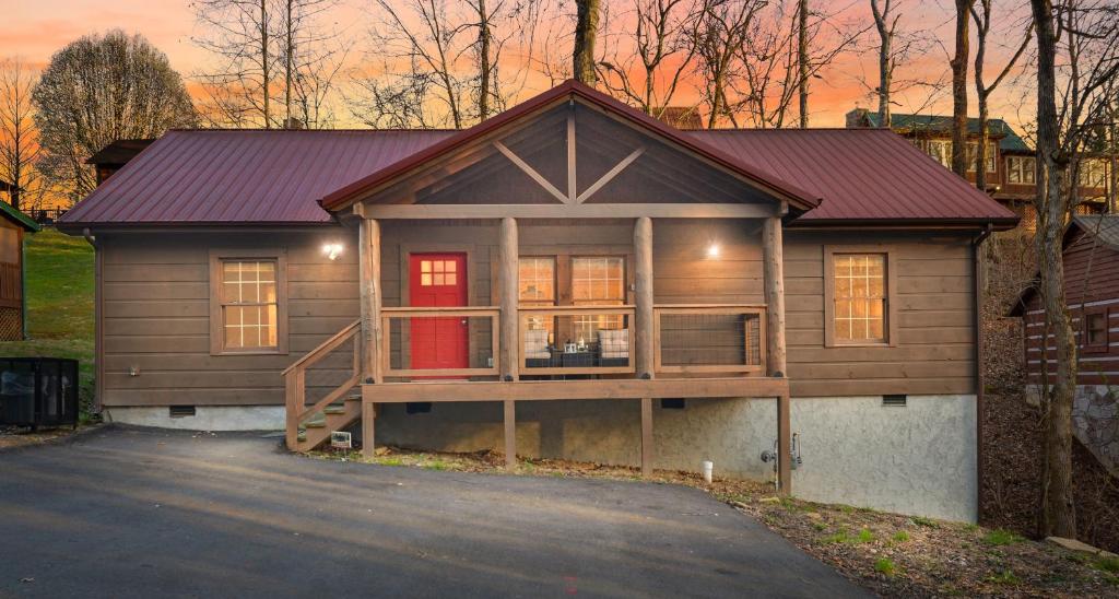 a small house with a porch and a garage at Tsaliwood Cabin in Sevierville