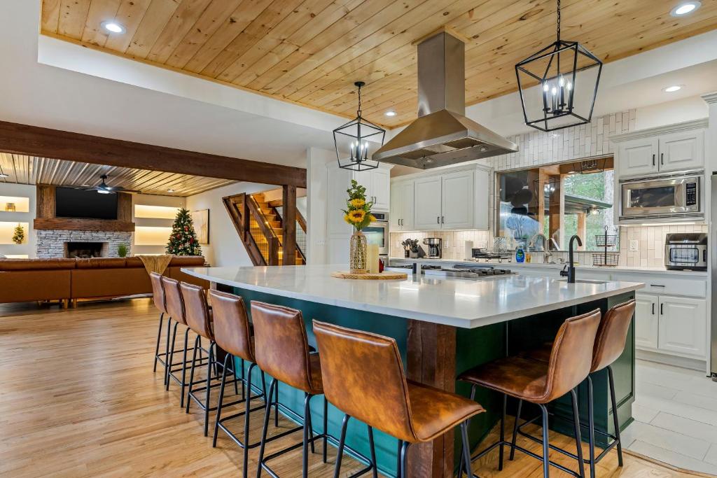 a kitchen with a large island with bar stools at Majestic Manor in Blue Ridge